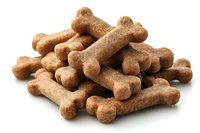 Pile of brown dog bone treats isolated on white background for pet food advertising and canine nutrition concepts.