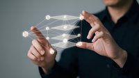 Man in dark clothing holding transparent digital network structure with glowing connection points, representing data connectivity, cloud computing, and technology infrastructure for business solutions.
