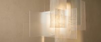 Modern pendant light fixture with layered frosted glass panels casting warm ambient glow, suitable for contemporary interior design and lighting product visualization.