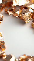 Shimmering copper metallic fragments create frame border on white background, macro shot with selective focus and bokeh effect for luxury design projects.