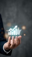 Businessman hand presenting glowing shopping cart and growth chart icons representing e-commerce sales increase and retail business success.