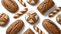 Assorted artisan breads including whole grain loaves, crusty baguettes, and round boules arranged on white background for bakery, food, and culinary design projects.
