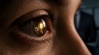 Closeup of a woman's eye with warm golden light reflecting in the iris, conveying vision, awareness, and insight for creative and editorial projects.
