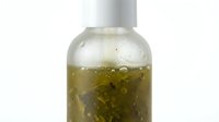 Clear glass bottle with white cap containing olive-green herbal infusion or oil with visible botanical particles, isolated on white background for cosmetic, wellness, or skincare product design use.