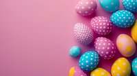 Colorful Easter eggs with polka dot pattern on pink background. Decorated eggs in pastel blue, yellow and pink create festive spring holiday composition.