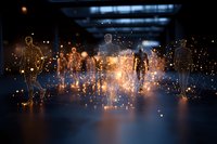 Glowing silhouettes of people walking in dark space with magical light particles and sparkles creating ethereal atmosphere for spiritual and technology concepts.