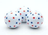 Patriotic golf balls with red and blue stars isolated on white background, ready for sports marketing, promotional merchandise, and athletic design projects.