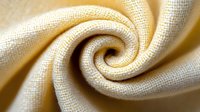Cream colored woven fabric twisted in elegant spiral swirl pattern. Natural textile material with detailed weave texture for fashion and interior design projects.