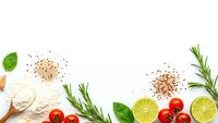 Fresh cooking ingredients frame with flour, cherry tomatoes, lime, rosemary and basil herbs on white background for culinary recipes and meal preparation.
