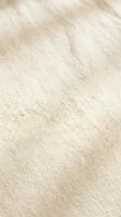 Soft beige sand texture with gentle wave patterns and natural grain detail for backgrounds and design projects.