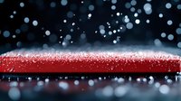Dramatic red surface with falling snow and fog creating atmospheric winter scene against dark background. Macro photography captures frozen moment in time.