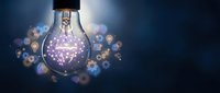 Glowing light bulb with purple brain inside surrounded by floating icons representing innovation, creativity and bright ideas for business concepts.