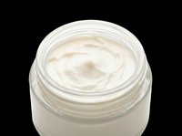 Open glass jar of white face cream isolated on transparent background, ready for beauty, skincare, cosmetic product design, stickers, and print on demand use.