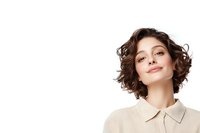 Young Caucasian woman with short curly brown hair and natural makeup smiling confidently against white background, wearing beige collared shirt. Professional portrait.