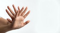 Multiple hands reaching upward against white background showing teamwork, unity and collaboration in business or community support concept.