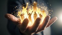 Hand holding glowing silhouettes of celebrating people with raised arms surrounded by golden light particles and magical sparkles for teamwork concepts.