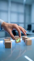 Businessman hand selecting wooden cube with green checkmark from group of blocks on modern office desk representing choice and decision making.