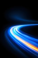 Dynamic curved light trails glowing in blue and orange neon colors against dark background create futuristic motion effect for technology concepts.