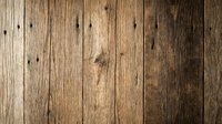Rustic weathered wooden planks background with natural grain texture and nail holes for vintage design projects and country style decorations.