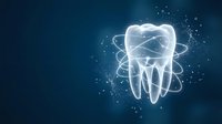 Glowing white tooth with orbital rings and sparkling particles on dark blue background for dental care and oral health concepts.