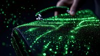 Glowing green digital particles flow through dark space creating futuristic technology pattern with bokeh light effects and motion blur for tech backgrounds.