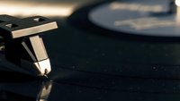 Vintage turntable cartridge and stylus needle on vinyl record player, analog music equipment for DJ mixing and audiophile listening experience.