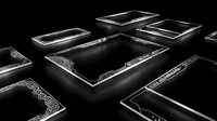 Elegant black ornate picture frames with decorative borders arranged on dark surface for luxury interior design and artwork display.