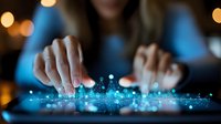 Digital transformation concept with glowing blue interface and female hands interacting with futuristic touchscreen technology in dark ambient setting.