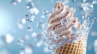 Soft serve ice cream cone with water splashes and ice cubes on blue background. Dynamic frozen dessert photography capturing sweet refreshment moment.