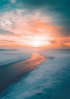Dramatic winter sunset over frozen lake with orange sky reflecting on melting ice stream, creating contrast between warm sunlight and cool blue snow landscape.