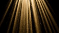 Golden light rays streaming down through darkness with sparkling dust particles creating dramatic illumination for stage and theater backgrounds.