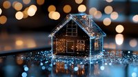 Glowing house silhouette with magical bokeh lights creating dreamy atmosphere against dark background. Decorative miniature home with sparkles and blue tones for holiday season.