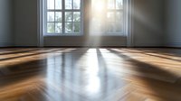 Sunlight streaming through windows casting dramatic rays and shadows on polished hardwood floor in empty minimalist room with white walls and natural lighting.