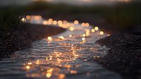 Magical evening light reflects on wet cobblestone path creating golden bokeh effect. Romantic rainy atmosphere with glowing puddles and blurred background.