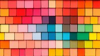 Colorful geometric pattern of overlapping square tiles arranged in rows creating vibrant rainbow gradient effect, modern abstract background design for presentations.