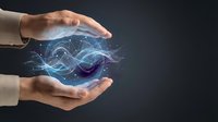 Hands holding glowing digital wave energy between palms, representing innovation, technology, and future concepts for business and science applications.