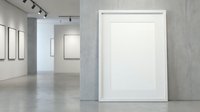 Modern art gallery interior with blank white canvas frames on concrete walls for artwork display and exhibition mockup purposes.