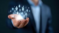 Professional in suit holding glowing network of connected people icons floating above palm, representing human resources management and digital networking concept.