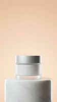 Cosmetic jar with silver lid on marble podium against neutral beige background, suitable for skincare, beauty product packaging, and wellness branding.