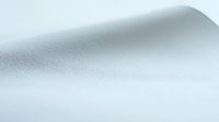 Minimalist light gray textured background with subtle gradient and soft shadow effect creates clean, modern surface for design projects and presentations.