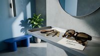 Modern entryway console with sunglasses, keys, and welcome home card in a stylish blue and gray interior with natural light.