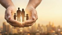 Protective hands holding family silhouettes against golden sunset sky over blurred city skyline representing care, security and life insurance coverage.