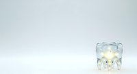 Transparent glass jellyfish figurine with warm glowing lights inside, isolated on white background, ready for design projects, merchandise, and decorative applications.