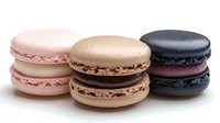 Three colorful macarons with smooth shells and cream filling on white background, isolated dessert cookies for bakery design and culinary projects.