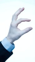 Male hand in business attire gesturing with open palm against white background, suitable for corporate presentations, websites, and marketing materials.