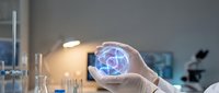 Scientist in laboratory holding glowing digital globe showing global network connections, representing innovation, technology research, and international data exchange in modern science.