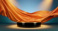 Black cylindrical podium with flowing orange silk fabric backdrop creating elegant product display stage for luxury presentations and branding.