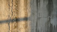 Weathered concrete wall with peeling paint and rust stains showing urban decay and industrial deterioration for grunge backgrounds and texture designs.