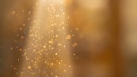 Golden bokeh light rays streaming through warm amber background with floating particles and magical glow effects for luxury design projects.