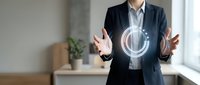 Businessman in dark blazer and white shirt holding glowing digital circle interface, representing technology, innovation, and business solutions for corporate and digital transformation concepts.